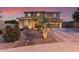 Charming two-story home with a well-manicured front yard and a cozy desert stream landscape feature at 1179 E Regent Dr, Gilbert, AZ 85298
