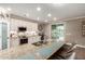 Stylish kitchen with large island, breakfast bar, granite countertops, and modern appliances at 1179 E Regent Dr, Gilbert, AZ 85298