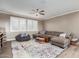 Cozy living room with large sectional sofa, colorful rug, and abundant natural light at 1179 E Regent Dr, Gilbert, AZ 85298