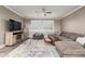 Comfortable living room featuring a large sectional sofa, TV, and abundant natural light at 1179 E Regent Dr, Gilbert, AZ 85298