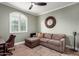 Stylish office/bedroom featuring a comfortable chaise lounge, ceiling fan, and lots of natural light from a shuttered window at 1179 E Regent Dr, Gilbert, AZ 85298