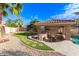 This backyard kitchen features a covered dining area, food prep area, and views of the pool at 1179 E Regent Dr, Gilbert, AZ 85298