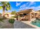 Outdoor kitchen and dining area overlooking the pool, with tile flooring and a flat-screen television at 1179 E Regent Dr, Gilbert, AZ 85298