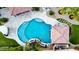 Aerial view of a luxury pool and patio area with unique shape and water features at 1179 E Regent Dr, Gilbert, AZ 85298