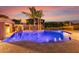 Gorgeous pool with water features, palm trees and outdoor kitchen for easy entertaining at 1179 E Regent Dr, Gilbert, AZ 85298