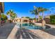 A beautiful blue pool is surrounded by an outdoor kitchen and elegant stonework at 1179 E Regent Dr, Gilbert, AZ 85298