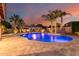 Inviting backyard pool area with travertine decking, mature palms, and a stylish gazebo at 1179 E Regent Dr, Gilbert, AZ 85298