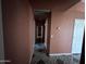 Long hallway featuring decorative tile flooring and neutral walls at 15329 W Melissa Ln, Surprise, AZ 85374