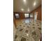 Living room featuring decorative tile floors and ample natural light from multiple windows at 15329 W Melissa Ln, Surprise, AZ 85374