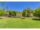 Spacious backyard with well maintained lawn and a yellow storage shed at 1609 E Williams N St, Tempe, AZ 85281