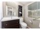 Cozy bathroom featuring a dark vanity, toilet and a framed mirror at 1609 E Williams N St, Tempe, AZ 85281
