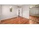 A spacious bedroom with hardwood floors, an arched mirror, and a ceiling fan at 1609 E Williams N St, Tempe, AZ 85281