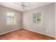 Well-lit bedroom featuring hardwood floors, neutral walls, and two windows at 1609 E Williams N St, Tempe, AZ 85281