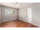 Bright bedroom featuring hardwood floors, neutral walls, and a ceiling fan at 1609 E Williams N St, Tempe, AZ 85281