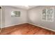 Neutral bedroom featuring hardwood floors, natural light, and ceiling fan at 1609 E Williams N St, Tempe, AZ 85281