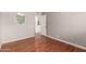 Bedroom showcasing hardwood floors, neutral walls, and a door leading to the kitchen at 1609 E Williams N St, Tempe, AZ 85281