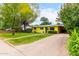 Quaint yellow home features lush landscaping and covered parking, adding charm and functionality at 1609 E Williams N St, Tempe, AZ 85281