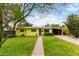 Charming yellow home features a well-maintained front yard, covered parking, and a welcoming entrance at 1609 E Williams N St, Tempe, AZ 85281