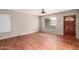 Inviting living room with hardwood floors, a large window, and a classic wooden front door at 1609 E Williams N St, Tempe, AZ 85281