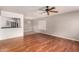 Spacious living room featuring hardwood floors, a ceiling fan, and ample natural light at 1609 E Williams N St, Tempe, AZ 85281