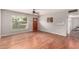 Bright living room with hardwood floors, a ceiling fan, and a view to the front yard at 1609 E Williams N St, Tempe, AZ 85281