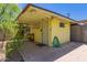 Outdoor patio area attached to a storage shed, featuring a hose and bench at 1609 E Williams N St, Tempe, AZ 85281