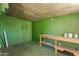 Interior of a green shed featuring a wooden workbench and storage space at 1609 E Williams N St, Tempe, AZ 85281