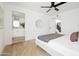 Bedroom featuring a modern ceiling fan and ensuite bath with double sinks and ample counter space at 1631 E Gardenia Ave, Phoenix, AZ 85020