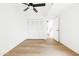 Bright, empty bedroom featuring wood floors, bi-fold closet doors, and a modern ceiling fan at 1631 E Gardenia Ave, Phoenix, AZ 85020