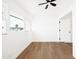 Upstairs bedroom showcasing bright interior with natural light, hardwood flooring, and a ceiling fan at 1631 E Gardenia Ave, Phoenix, AZ 85020