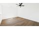 Vacant bedroom showcasing light hardwood flooring and a modern ceiling fan at 1631 E Gardenia Ave, Phoenix, AZ 85020