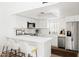 Well-lit kitchen boasting white countertops, stainless steel appliances, and a breakfast bar at 1631 E Gardenia Ave, Phoenix, AZ 85020