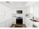 Bright kitchen featuring white cabinets, modern appliances, and sleek countertops at 1631 E Gardenia Ave, Phoenix, AZ 85020