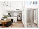 Modern kitchen with stainless steel appliances, white cabinetry, and an adjacent dining area at 1631 E Gardenia Ave, Phoenix, AZ 85020