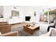 Bright living room featuring a fireplace, stylish decor, and sliding doors to a private patio at 1631 E Gardenia Ave, Phoenix, AZ 85020