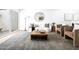 Open-concept living area featuring neutral tones, stylish furnishings and light hardwood flooring throughout at 1631 E Gardenia Ave, Phoenix, AZ 85020