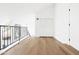 Light filled loft area with black metal railing and view of first floor at 1631 E Gardenia Ave, Phoenix, AZ 85020