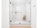 Elegant shower with frameless glass enclosure, white marble tiling, and a built-in niche at 1631 E Gardenia Ave, Phoenix, AZ 85020