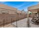 A shaded back patio area offers comfortable seating, secure fencing, and a well-maintained block wall for privacy at 1650 S Crismon Rd # 13, Mesa, AZ 85209
