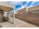 A covered outdoor seating area on a back patio featuring desert landscaping and a block fence for privacy at 1650 S Crismon Rd # 13, Mesa, AZ 85209