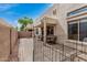 This outdoor back patio area has comfortable seating and features a partial protective fence for safety and security at 1650 S Crismon Rd # 13, Mesa, AZ 85209