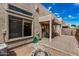 The covered back patio includes a propane firepit and easy access to the residence through a sliding glass door at 1650 S Crismon Rd # 13, Mesa, AZ 85209