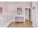 Bright Bedroom featuring a hardwood floor, crib, and changing table at 1650 S Crismon Rd # 13, Mesa, AZ 85209