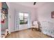Beautiful Bedroom featuring a white crib and white curtains at 1650 S Crismon Rd # 13, Mesa, AZ 85209