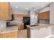 Bright kitchen featuring granite countertops, light wood cabinets, and a black refrigerator at 1650 S Crismon Rd # 13, Mesa, AZ 85209