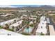 Aerial view of community with a pool, lush palm trees, and mountain backdrop at 16510 E Palisades Blvd # 42, Fountain Hills, AZ 85268