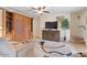 Comfortable living room showcasing tile floors, a ceiling fan, and a built-in wooden entertainment center at 16510 E Palisades Blvd # 42, Fountain Hills, AZ 85268