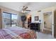 Bedroom featuring a ceiling fan, access to a balcony and glimpses of the en suite bathroom at 16510 E Palisades Blvd # 42, Fountain Hills, AZ 85268
