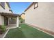 A lush backyard with an artificial lawn and an outdoor patio offers relaxation and entertainment at 16540 W Culver St, Goodyear, AZ 85338
