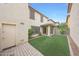 Artificial grass in the backyard of this home featuring an outdoor patio at 16540 W Culver St, Goodyear, AZ 85338
